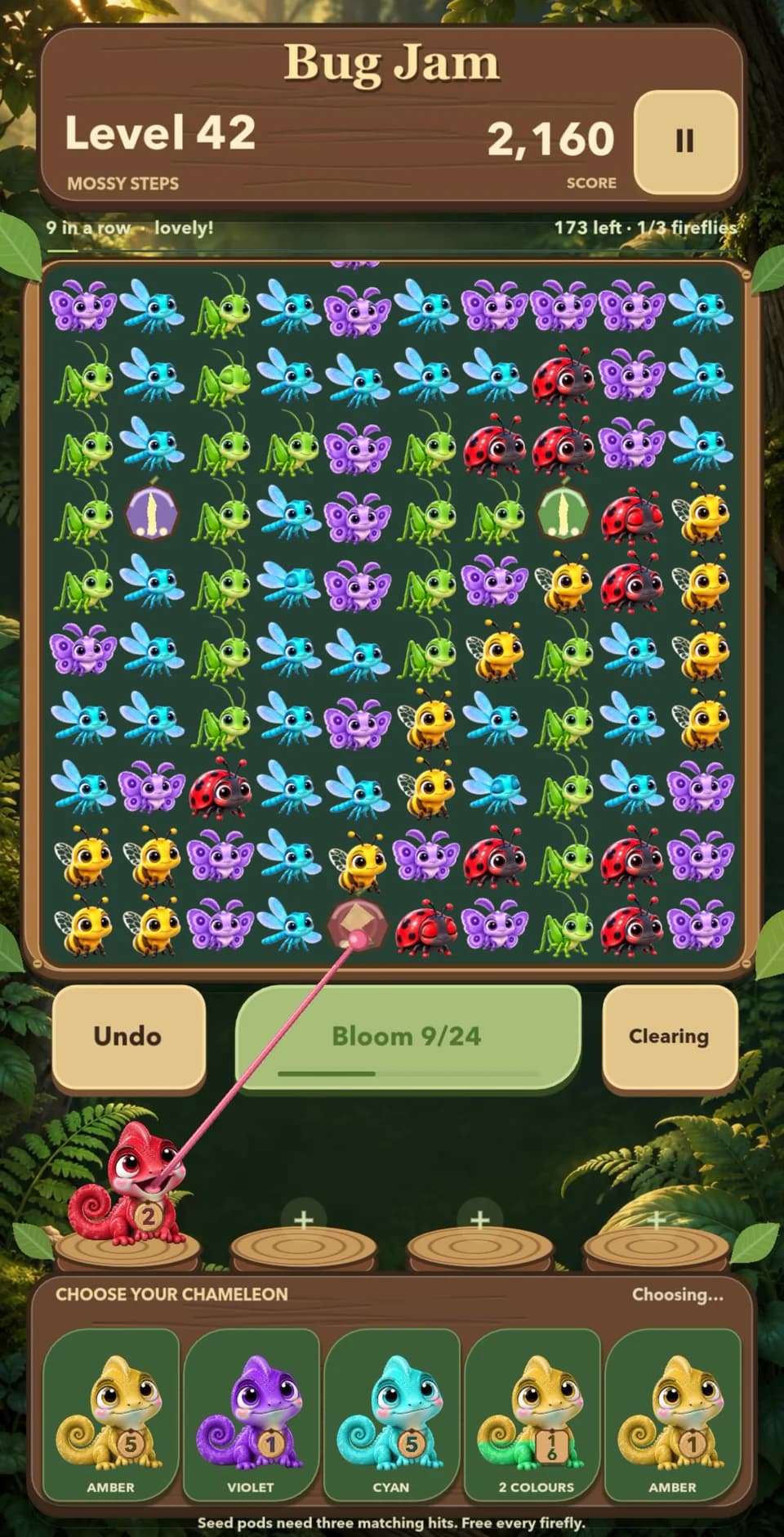 Level 42 in Mossy Steps: a red chameleon's tongue strikes a seed pod on the bottom row of the garden to free the firefly inside.